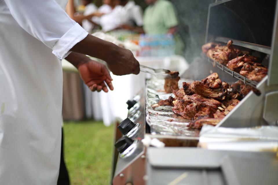 Man preparing BBQ chicken