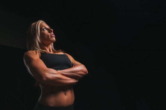Woman in great shape on black background