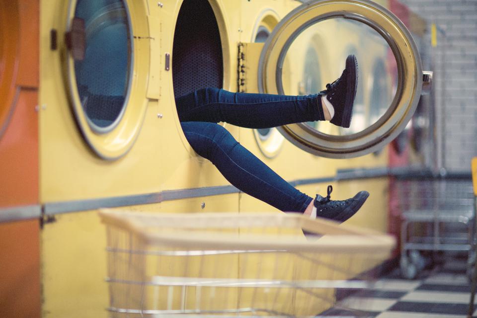 Women legs sticking out washing machine