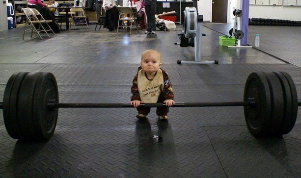Baby in a gym doing deadlift