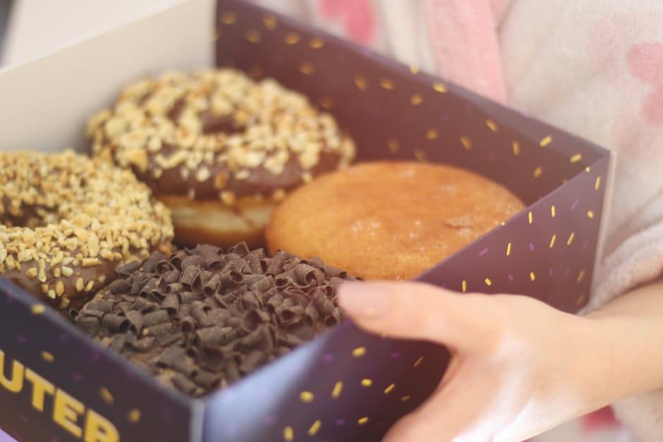 Woman holding donuts in box