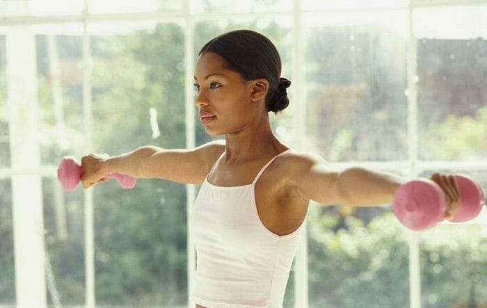 Woman doing arm circles with weights