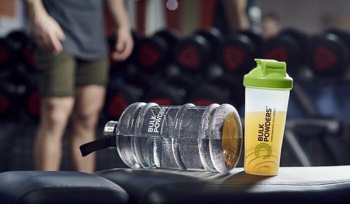 Water bottle and supplement in a bottle on a bench