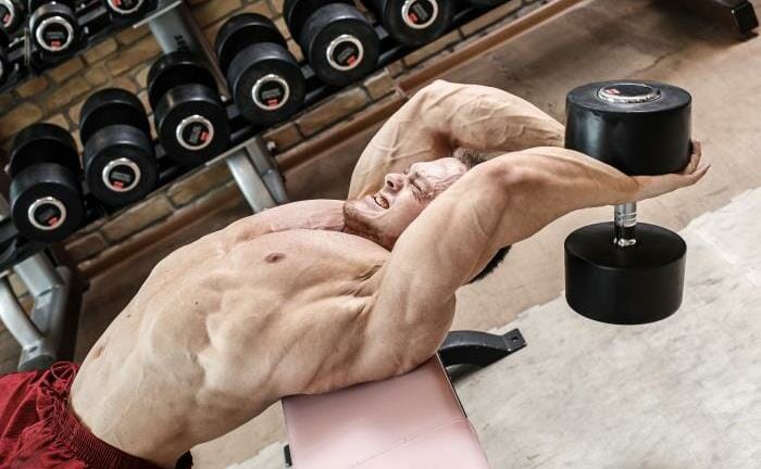 Man doing dumbbell pullover exercise