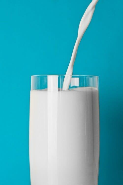 Glass of milk on a blue background