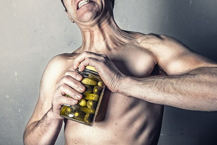Man opening a jar with pickles