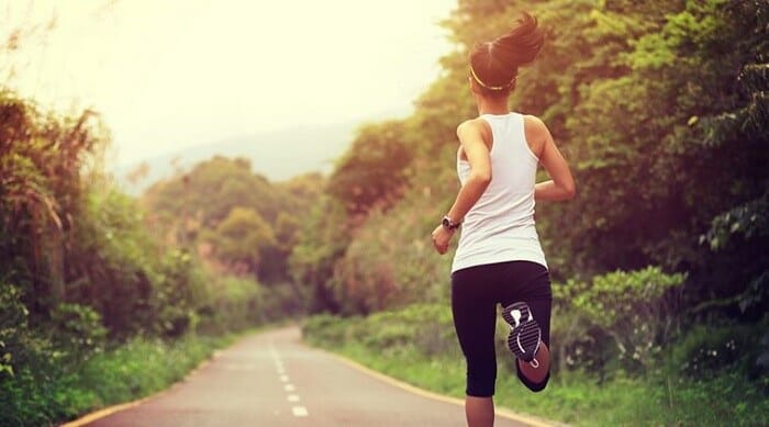 Woman jogging on a wood trail