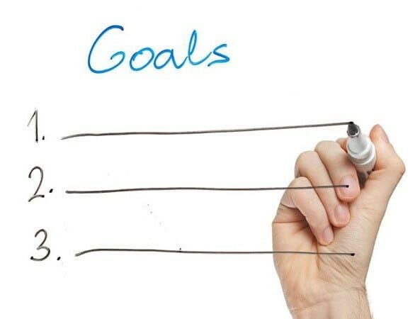 Hand writing goals on a board