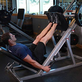 Man showing how to perform leg press