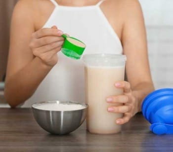 woman preparing protein mix shake
