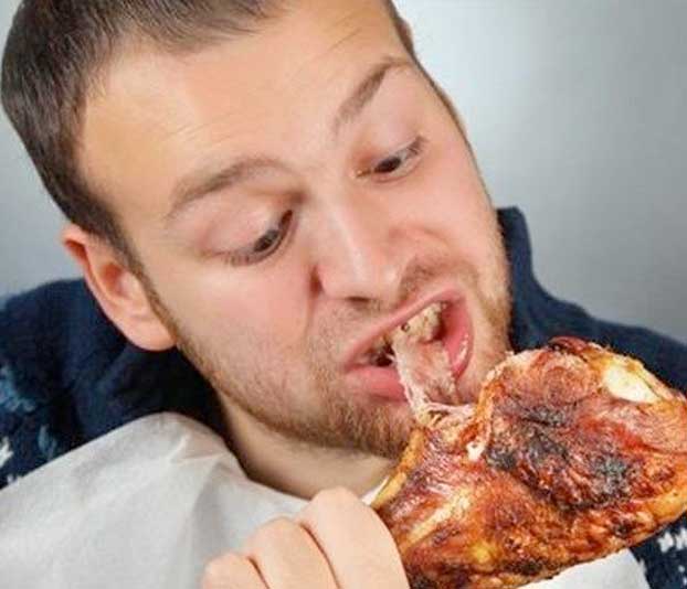 man eating a chicken