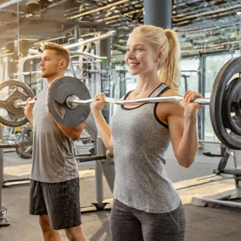 man and woman lifting at the gym