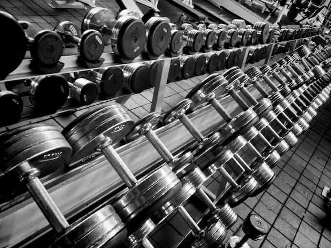 Black and white photo of dumbbells in a gym