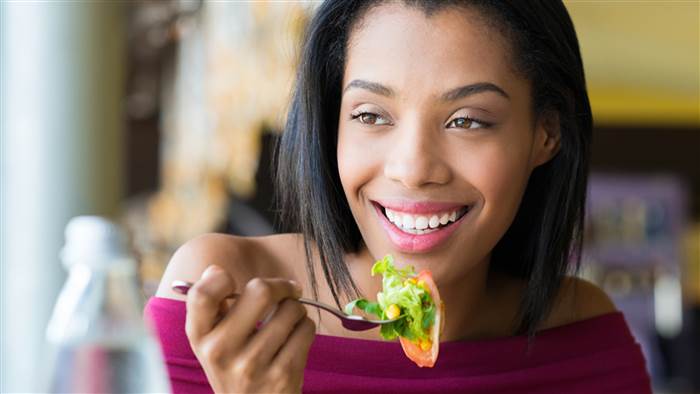 Woman eating her lunch with a fork