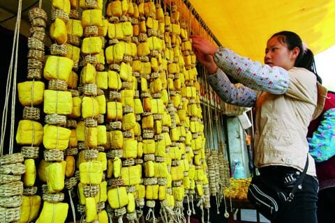 Woman on a market selling tofu