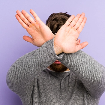 Man doing a cross gesture telling no