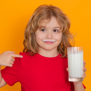 A kid drinking milk with protein shake