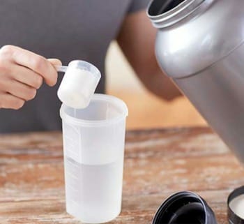 man preparing protein shake