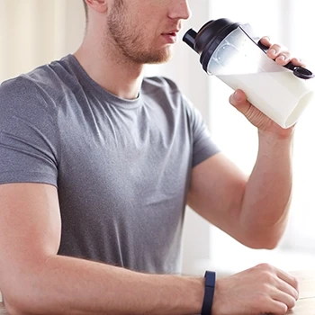 A man holding a shaker filled with BCAA