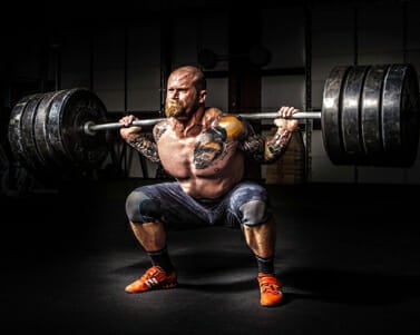 man holding a heavy barbell