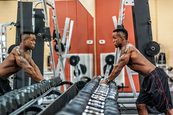 Man picking up dumbbells in the gym