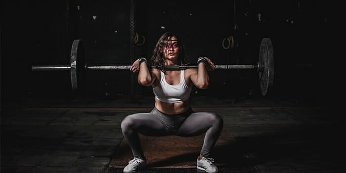photo-of-a-woman-doing-barbell-squats