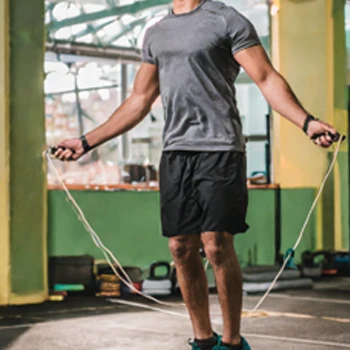 A man using a jumping rope for his workout