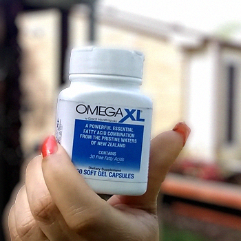 A woman holding an Omega XL product