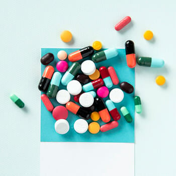 Close up shot of supplement pills on a blue table