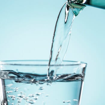 Close up shot of water being poured on a glass