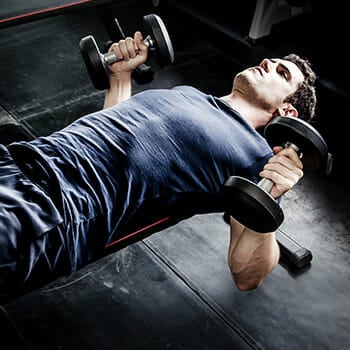 A person working out his endurance with dumbbells