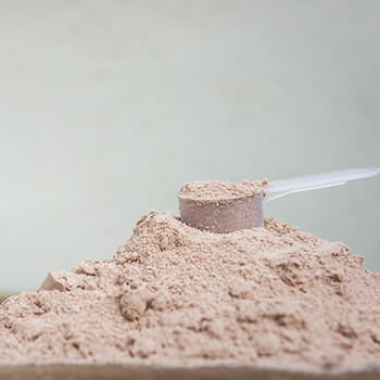 Close up shot of a scoop of protein powder