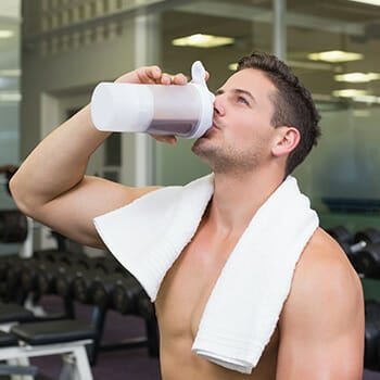 A person at the gym drinking BCAA