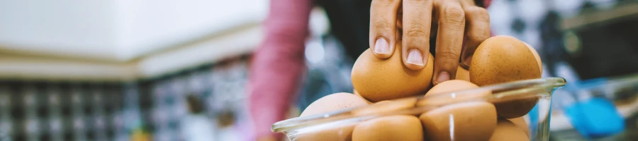 A person taking an egg full of protein from a bowl