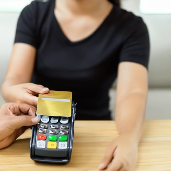 A person holding a credit card for payment