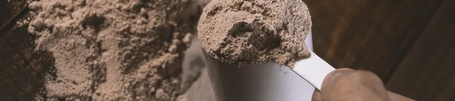 Scooping chocolate protein powder