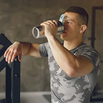 A man drinking water in the gym