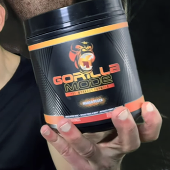 A hand holding a pre-workout product