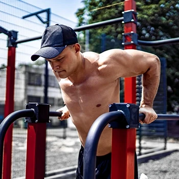 A man using calisthenics dip bars