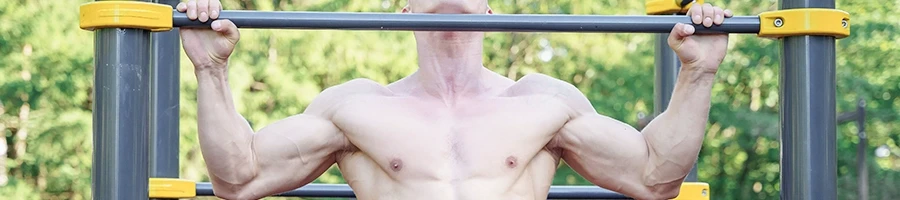 A strong man doing pull-ups