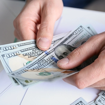 A close up shot of a person counting money