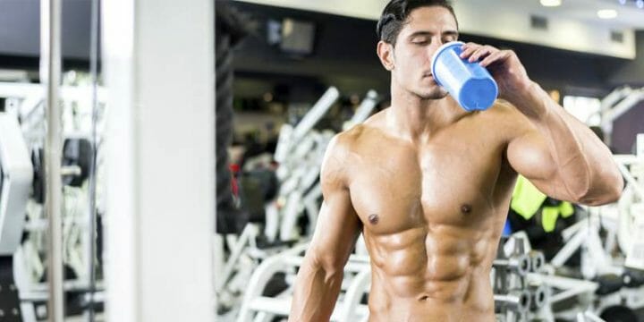 a buff male drinking the best multivitamins for muscle growth and bodybuilding