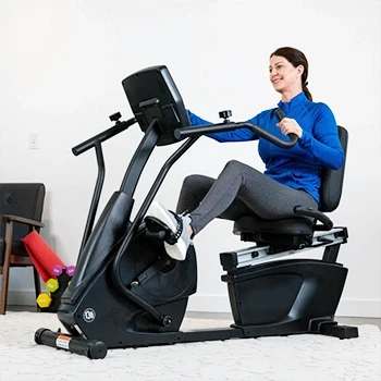 A woman using a recumbent bike with good size