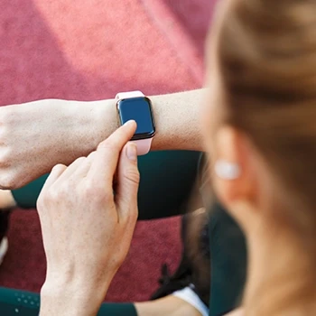 A woman wearing a fitness tracker watch with good display size