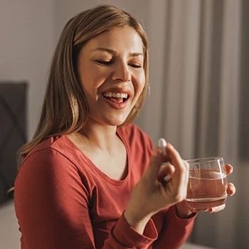 A woman taking collagen in the evening for health