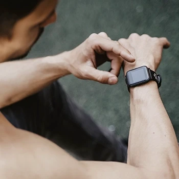 A strong man wearing a fitness tracker watch