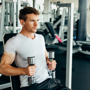 Fit man holding two dumbbells
