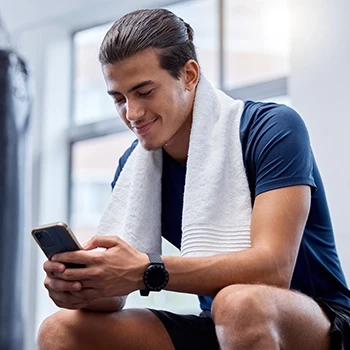 A man watching instruction videos on his phone