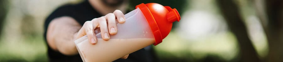 A guy holding a beverage