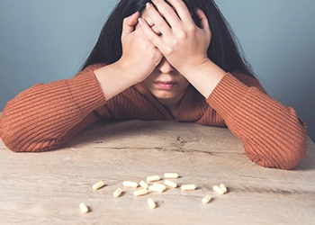 Woman having headache from supplement product she consumed